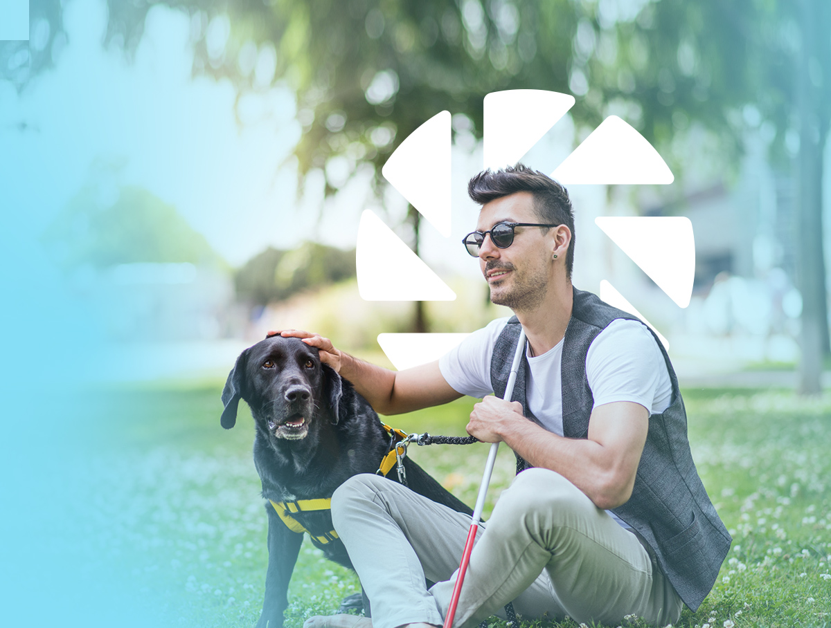 Man sat on the grass with his dog