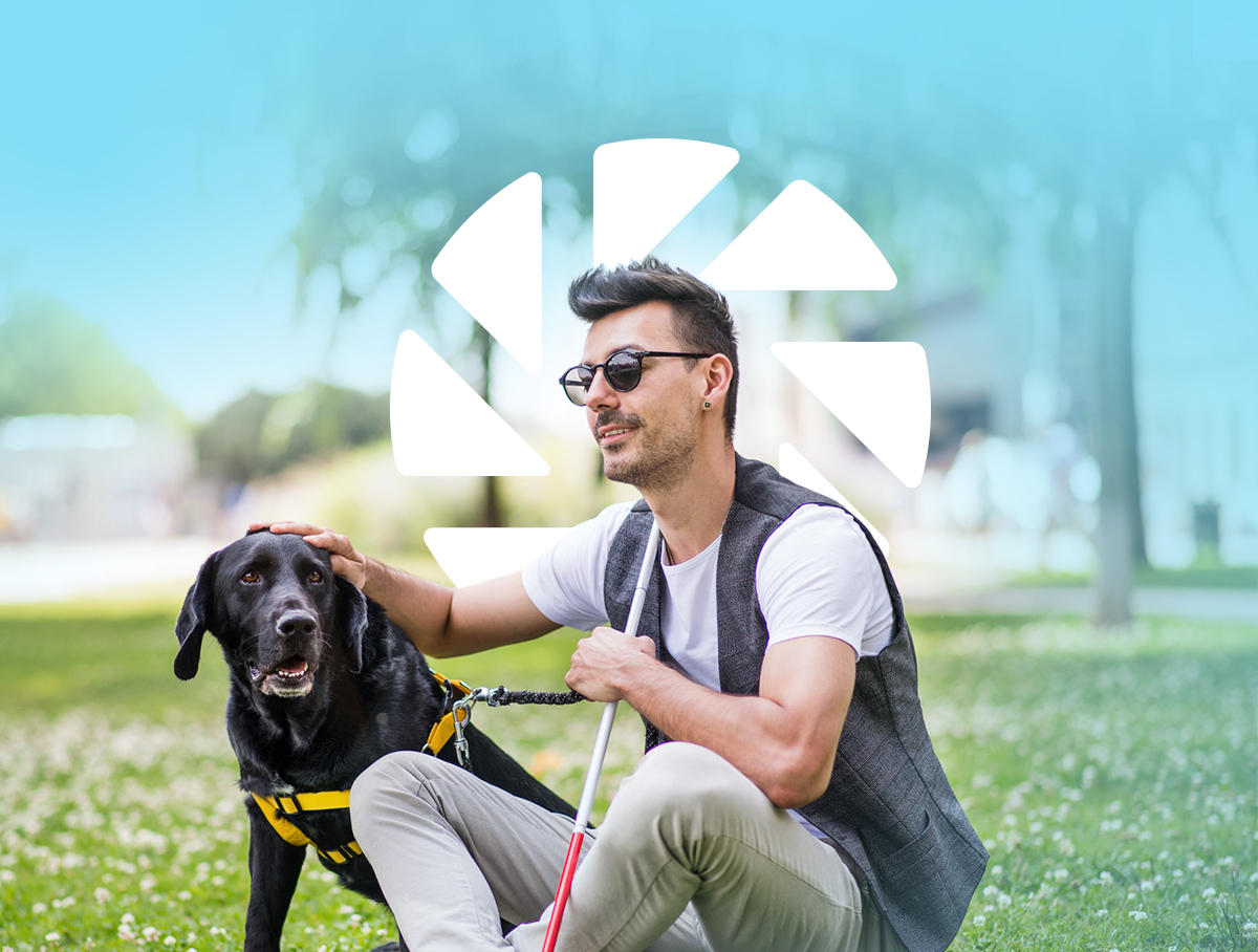 Man sat on the grass with his dog