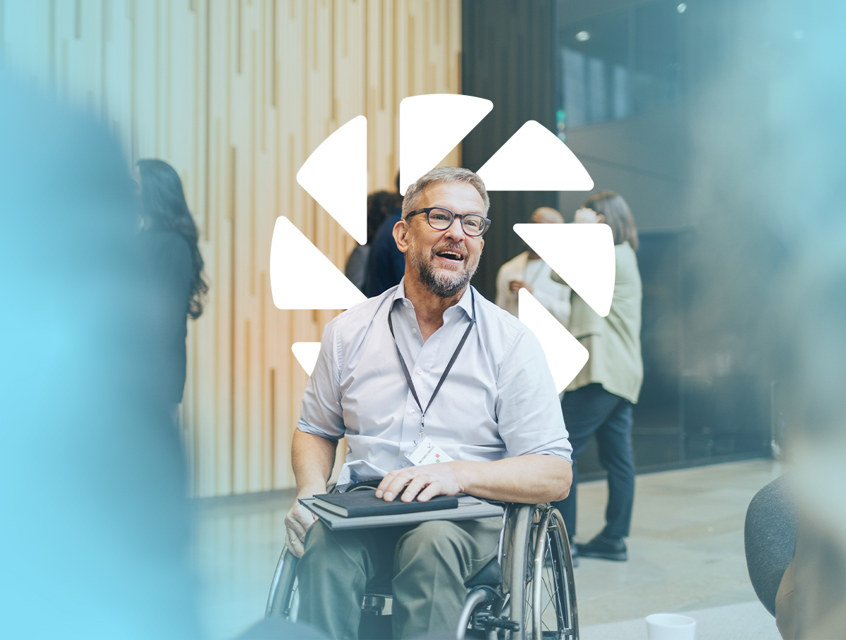 Man holding a notebook in a wheelchair