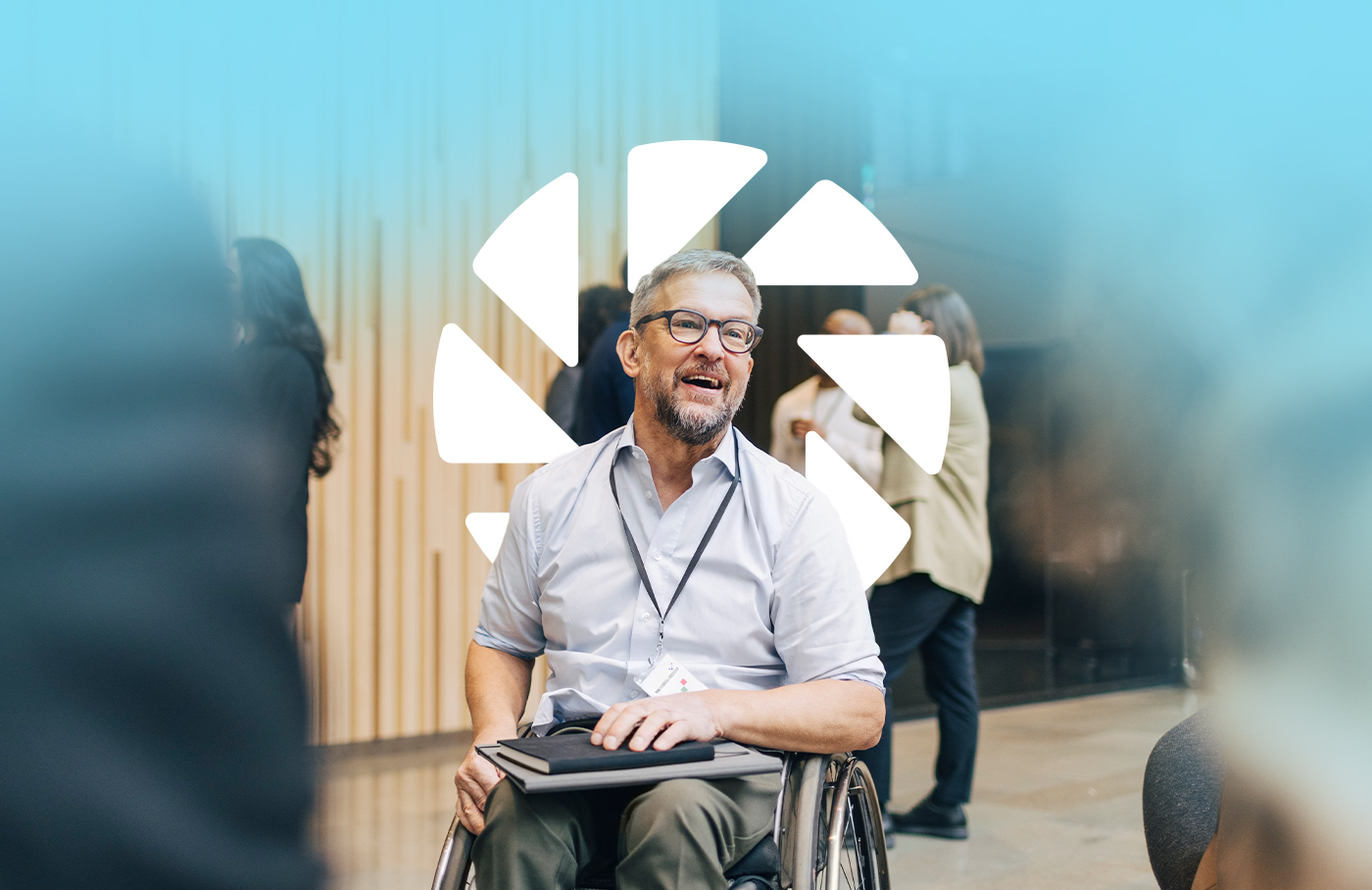 Man holding a notebook in a cheelchair